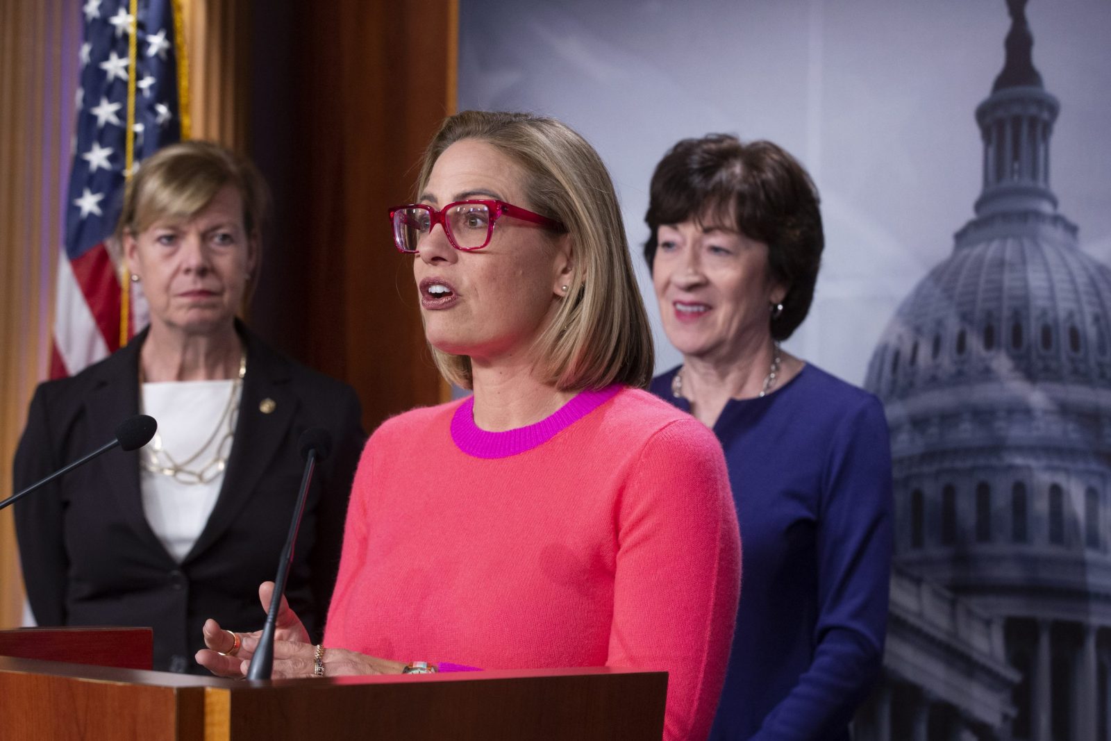 epa10337723 Democratic Senator from Arizona Kyrsten Sinema (C) speaks to the media after the Senate advanced the bill to protect same sex and interracial marriage beside Democratic Senator from Wisconsin Tammy Baldwin (L), and Republican Senator from Maine Susan Collins (R), during a news conference on Capitol Hill in Washington, DC, USA, 29 November 2022.  EPA/MICHAEL REYNOLDS