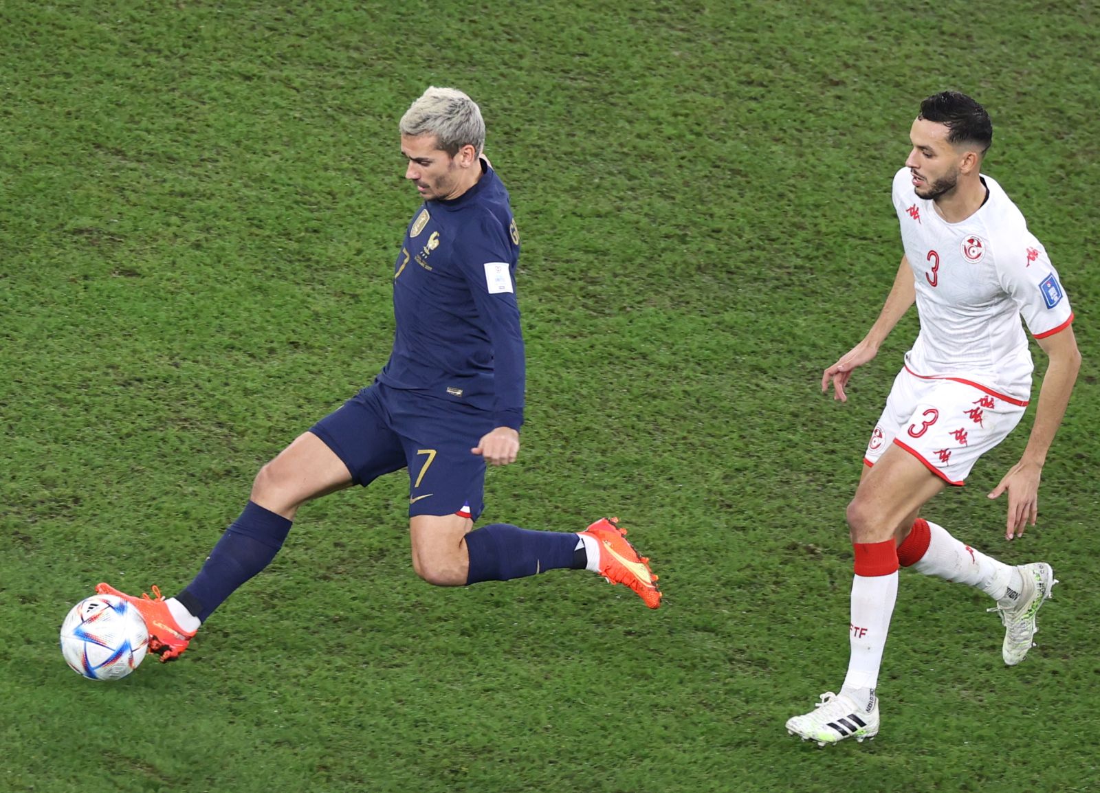 epa10339288 Antoine Griezmann (L) of France in action against Montassar Talbi of Tunisia during the FIFA World Cup 2022 group D soccer match between Tunisia and France at Education City Stadium in Doha, Qatar, 30 November 2022.  EPA/Mohamed Messara
