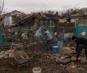 epa10339898 Victor Tsap(C) prepares wood for the winter season next to his destroyed house in the village of Pravdyne, outside Kherson, southern Ukraine, 30 November 2022. On its retreat from Kherson, the Russian army destroyed critical infrastructure in the city, including electricity and water supplies. Now, the constant Russian shellings, the lack of electricity, and running water in the town during the winter season has forced many locals to flee Kherson. Ukrainian troops entered Kherson on 11 November after the Russian army had withdrawn from the city which they captured in the early stage of the conflict, shortly after Russian troops had entered Ukraine in February 2022.  EPA/ROMAN PILIPEY