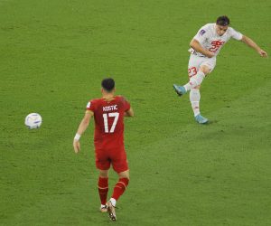 epa10345012 Xherdan Shaqiri (R) of Switzerland scores the 1-0 lead during the FIFA World Cup 2022 group G soccer match between Serbia and Switzerland at Stadium 947 in Doha, Qatar, 02 December 2022.  EPA/Ronald Wittek