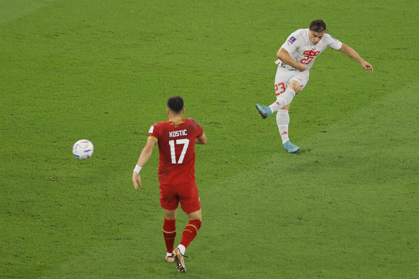 epa10345012 Xherdan Shaqiri (R) of Switzerland scores the 1-0 lead during the FIFA World Cup 2022 group G soccer match between Serbia and Switzerland at Stadium 947 in Doha, Qatar, 02 December 2022.  EPA/Ronald Wittek