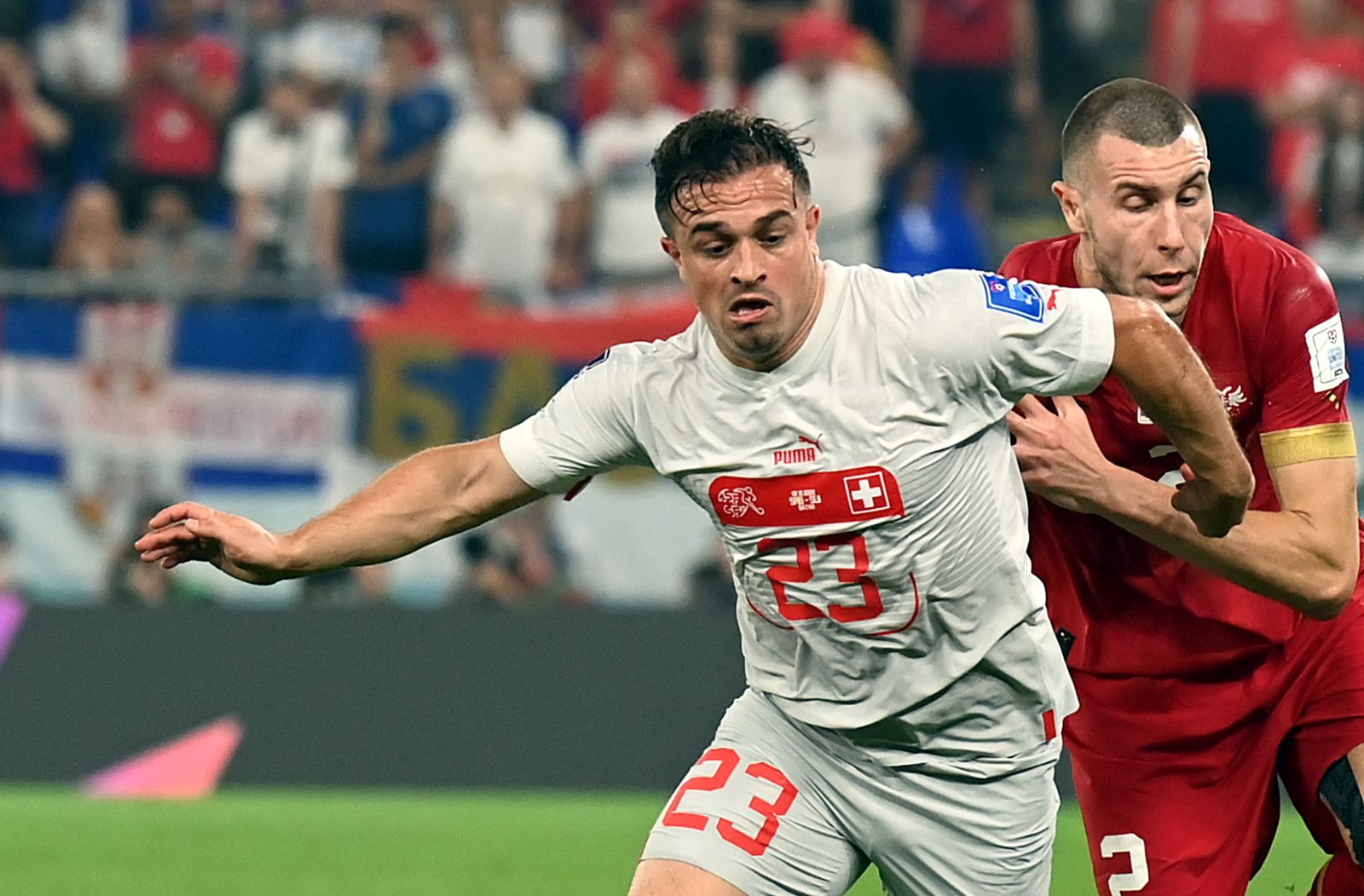 epa10345133 Strahinja Pavlovic (R) of Serbia in action against Xherdan Shaqiri of Switzerland during the FIFA World Cup 2022 group G soccer match between Serbia and Switzerland at Stadium 947 in Doha, Qatar, 02 December 2022.  EPA/Georgi Licovski