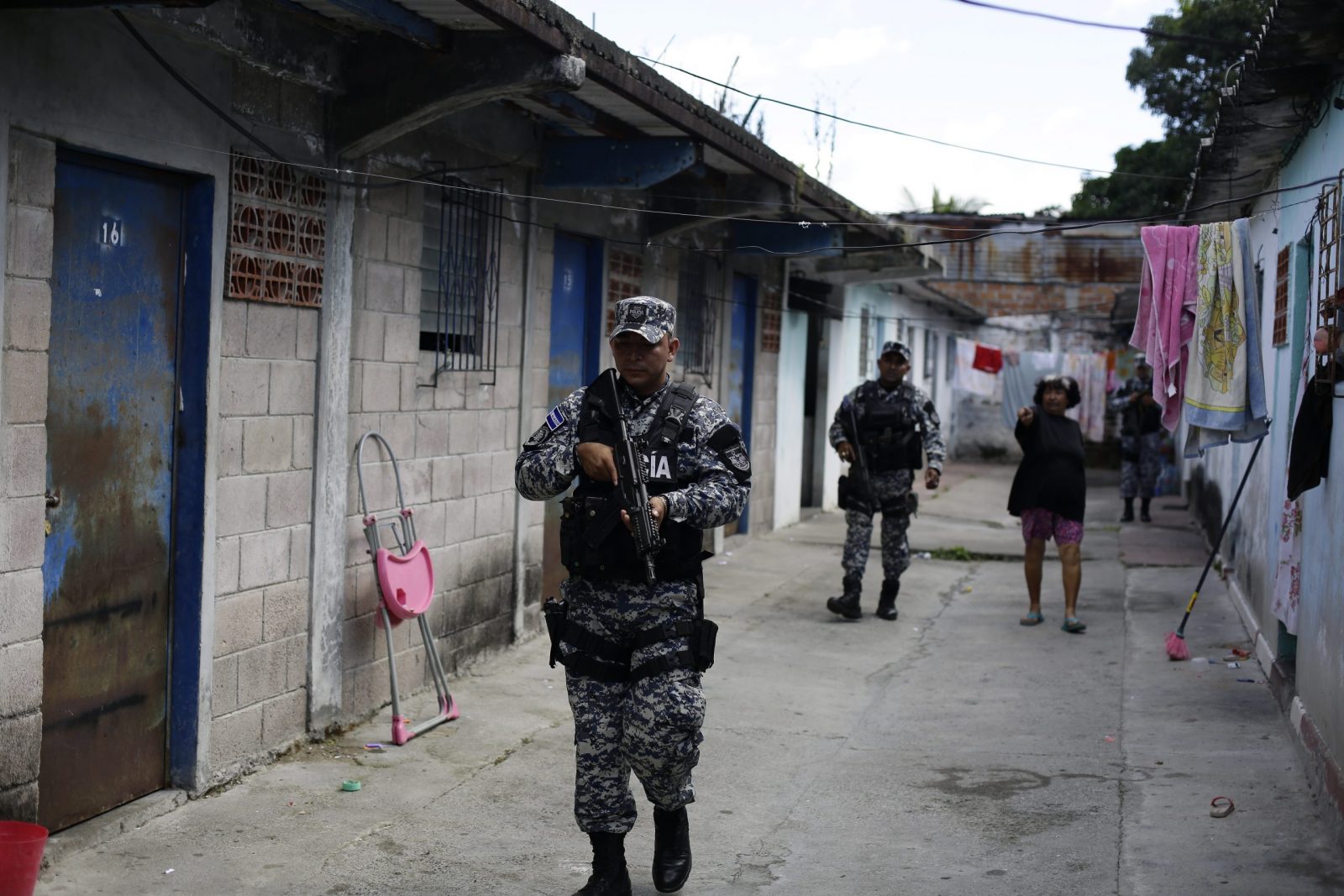 epa10346905 Salvadoran policemen patrol a street in Soyapango, El Salvador, 03 December 2022.Some 10,000 members of the Armed Forces and the National Civil Police (PNC) were deployed in the populous municipality of Soyapango to 'extract' gang members who have not yet been captured and continue the 'war against gangs'.  EPA/Rodrigo Sura