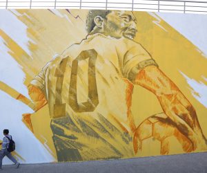 epa10351903 A man walks in front of a mural depicting Brazilian soccer legend Pele outside the Khalifa International Stadium in Doha, Qatar, 06 December 2022. Brazil will face Croatia in their FIFA World Cup 2022 quarter final soccer match on 09 December 2022.  EPA/ABIR SULTAN