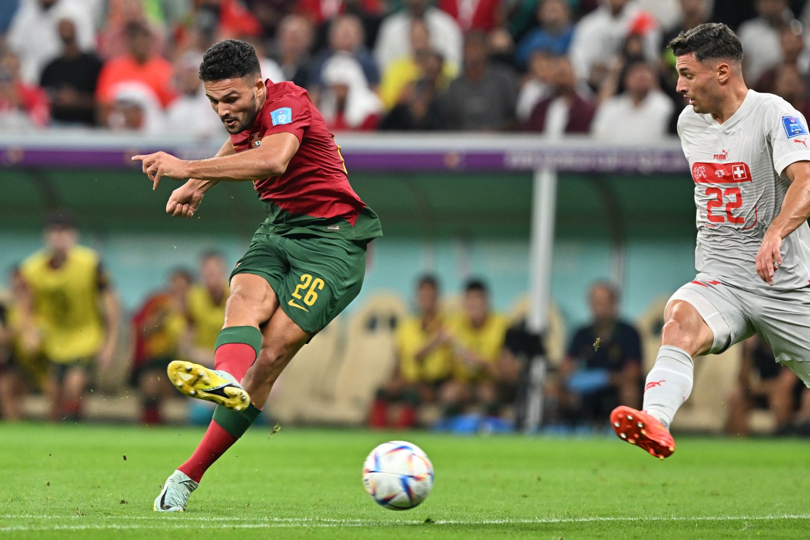 epa10352602 Goncalo Ramos (L) of Portugal scores the 1-0 during the FIFA World Cup 2022 round of 16 soccer match between Portugal and Switzerland at Lusail Stadium in Lusail, Qatar, 06 December 2022.  EPA/Noushad Thekkayil