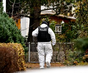 epa10353415 An police officer work during a raid in Berlin, Germany, 07 December 2022. Twenty-five people allegedly affiliated to the so-called Reichs Citizens (Reichsbuerger) movement were arrested in raids across Germany on suspicion of plotting to overthrow the government, a spokesperson for the Federal Prosecutor's office said. A group of far-right and ex-military figures are suspected to have planned to storm the parliament building, the Reichstag, and seize power.  EPA/Filip Singer