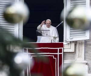 epa10354810 Pope Francis (C) is framed by the branches and decorations of a huge Christmas tree on St. Peter's Square as he delivers the Angelus prayer from a window of his rooms at the Apostolic Palace, Vatican City, 08 December 2022.  EPA/FABIO FRUSTACI