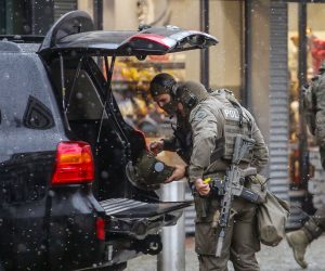 epa10359032 Armed members of a special police task force unit near a vehicle outside a shopping center in Dresden, Germany, 10 December 2022. Police announced on its social media that a hostage situation in the eastern German city of Dresden was over and that two people were released 'unharmed', after evacuating a shopping mall and its surroundings in the city center. A 40-year-old suspect died after suffering fatal injuries during the police operation to free the hostages, police added.  EPA/MATTHIAS SCHUMANN