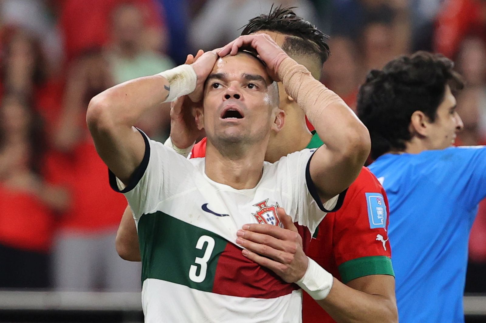 epa10359612 Jawad El Yamiq (C) of Morocco and Pepe (L) of Portugal react during the FIFA World Cup 2022 quarter final soccer match between Morocco and Portugal at Al Thumama Stadium in Doha, Qatar, 10 December 2022.  EPA/Ali Haider