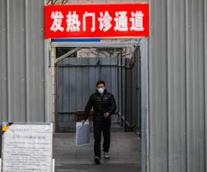 epa10364783 A man wearing a face mask walk out of the Fever outpatient channel in a hospital in Beijing, China, 14 December 2022. Following easing of Covid-19 curbs in Beijing, hospitals will cancel the adjustment of pre-test triage and first-level triage, nucleic acid test and antigen test result no longer require to enter the outpatient department.  EPA/WU HAO