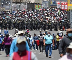 epa10365706 Police officers watch over a demonstration by supporters of deposed President Pedro Castillo, in Arequipa, Peru, 14 December 2022. The Peruvian Government declared on 14 December a state of emergency throughout the country for 30 days, which implies the suspension of assembly rights, inviolability of the home and freedom of transit, among others, while evaluating the possibility of declaring a curfew.  EPA/JOSE SOTOMAYOR