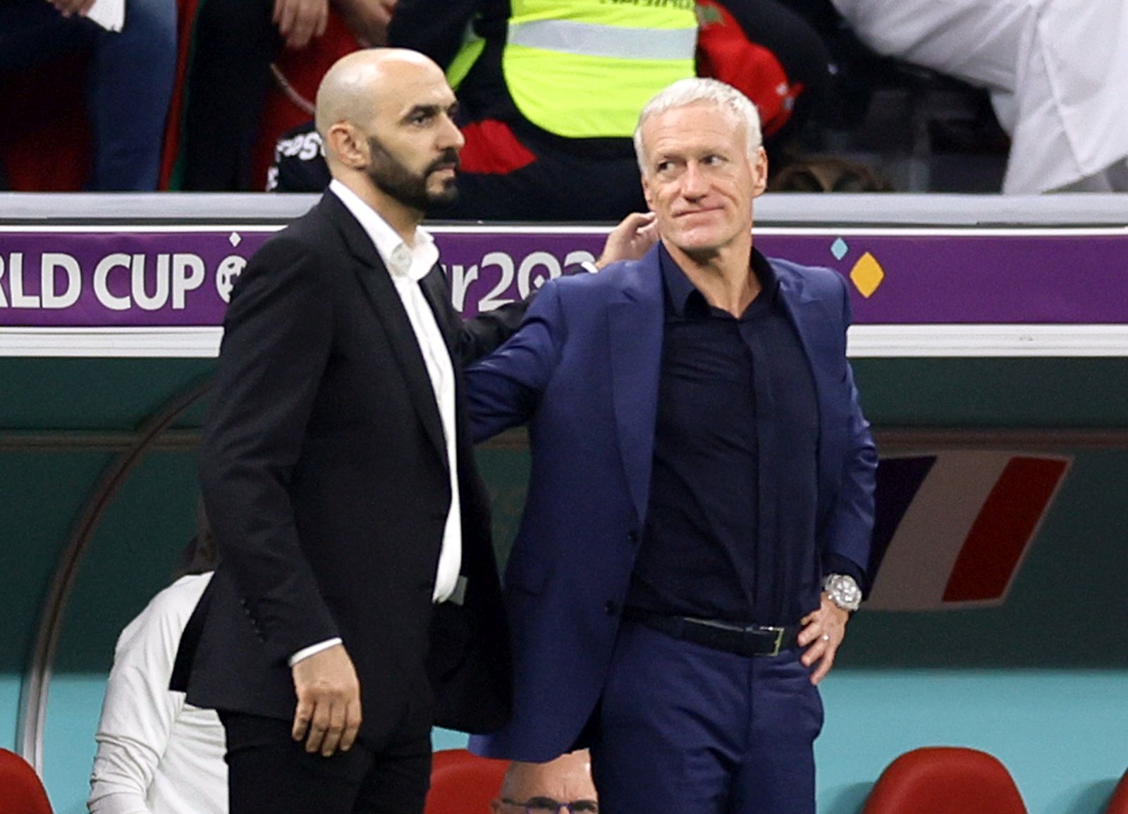 epa10366278 Head coach Walid Regragui of Morocco (L) and Head coach Didier Deschamps of France react after the FIFA World Cup 2022 semi final between France and Morocco at Al Bayt Stadium in Al Khor, Qatar, 14 December 2022.  EPA/Ronald Wittek