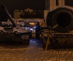epa10367523 Men look at Russian tanks destroyed in fights with the Ukrainian army, displayed in Mykhailivskyi Square, in Kyiv, Ukraine, 15 December 2022. Russian troops on 24 February entered Ukrainian territory, starting a conflict that has provoked destruction and a humanitarian crisis.  EPA/ROMAN PILIPEY