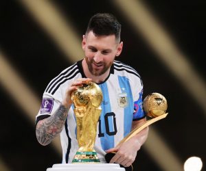 epa10373265 Lionel Messi of Argentina touches the World Cup trophy as he passes it after winning the golden ball award during the awards ceremony after the FIFA World Cup 2022 Final between Argentina and France at Lusail stadium, Lusail, Qatar, 18 December 2022.  EPA/Friedemann Vogel