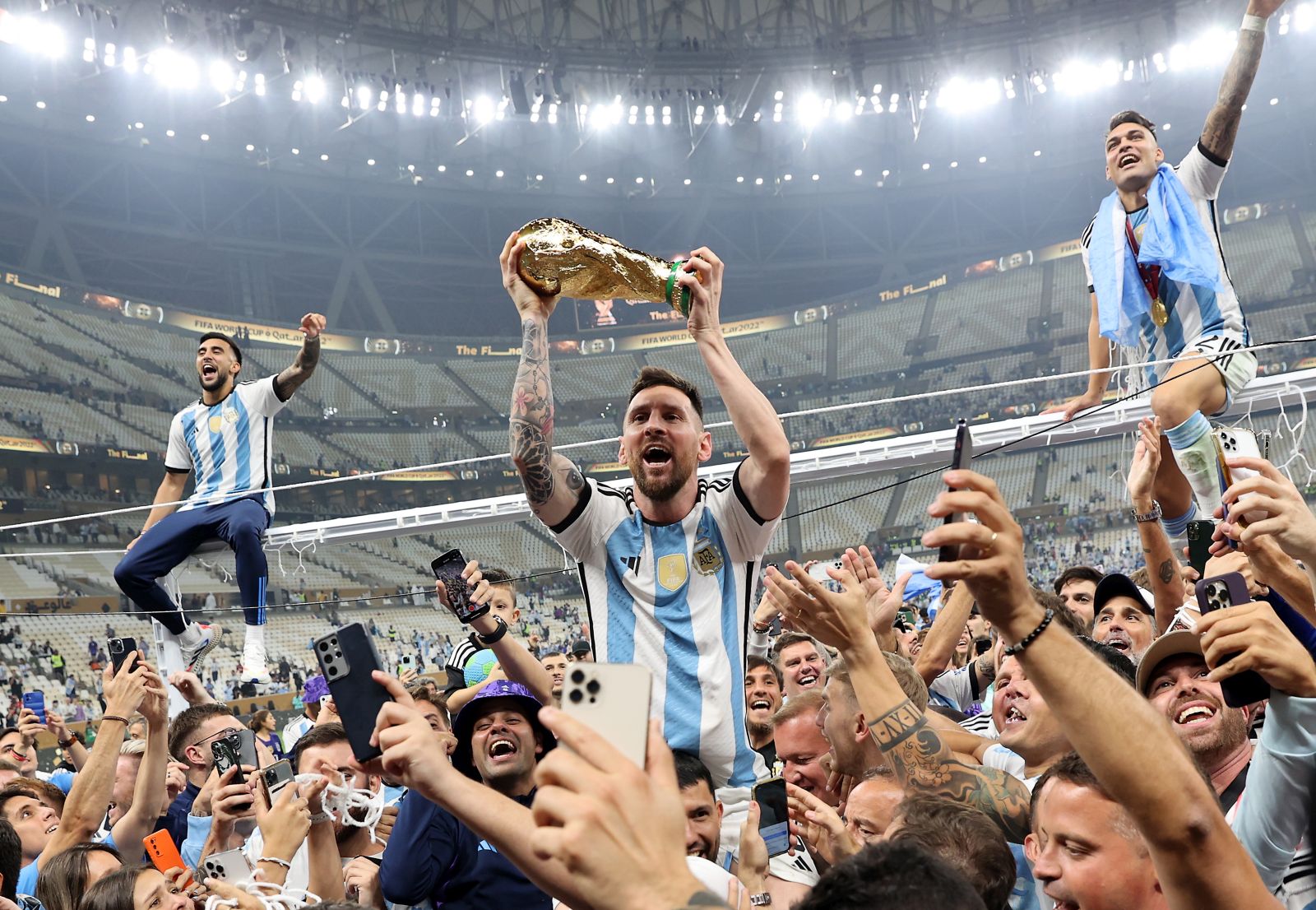 epaselect epa10373170 Lionel Messi of Argentina (C) lifts the trophy as he celebrates with teammates and fans winning  the FIFA World Cup 2022 Final between Argentina and France at Lusail stadium, Lusail, Qatar, 18 December 2022.  EPA/Tolga Bozoglu