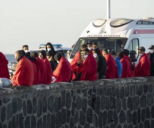 epaselect epa10375471 A group of migrants rest in the port of Arrecife after being rescued by the Spanish Maritime Safety and Rescue Society in the waters of northern Lanzarote, Spain, 21 December 2022. The 77 migrants, including four women and two children, tried to enter the Canary Islands aboard two small boats.  EPA/ADRIEL PERDOMO
