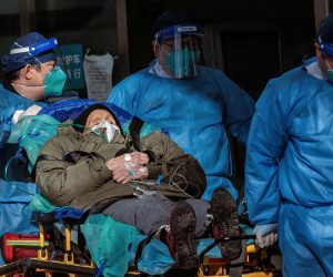 epa10376985 Health workers carry a person to the hospital, in Shanghai, China, 23 December 2022. Hospitals in China struggle to cope due to the rising number of COVID-19 cases. Since the abrupt lifting of domestic COVID-19 restrictions, cases have rocketed in China, causing businesses to close because employees are sick, schools are shifting to online classes, and pharmacies are struggling with the high demand. On 21 December, Shanghai Deji Hospital’s official WeChat account published a post with an estimated 5.43 million positive cases in the city and predicted that 12.5 million could get infected by the end of the year. The day after, the post was no longer available.  EPA/ALEX PLAVEVSKI