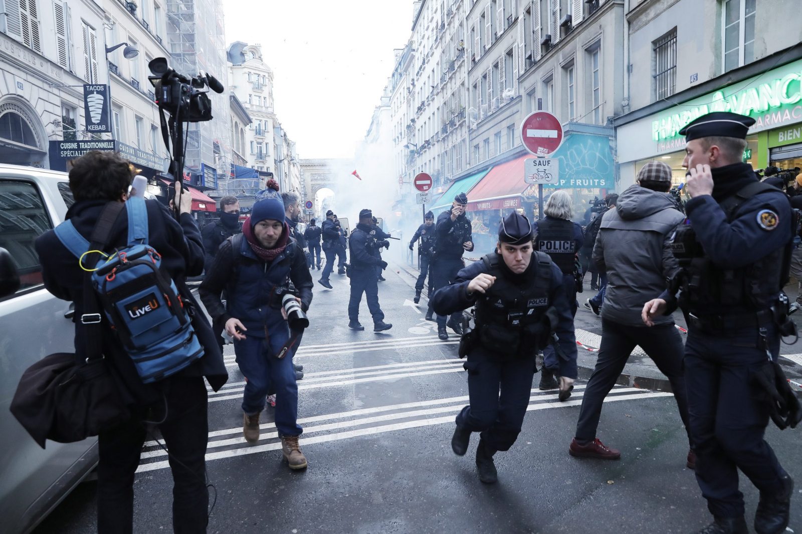 epa10377232 Protesters and French police officers clash after Minister Gerald Darmanin press conference following a shooting incident near a Kurdish cultural centre in Paris, France, 23 December 2022. The Paris Police Prefecture announced on its social media that a suspect was detained in connection to the incident.  EPA/TERESA SUAREZ