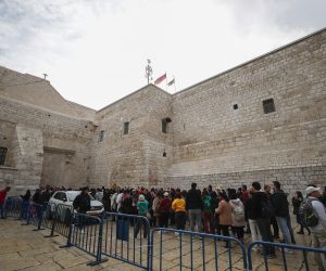 epa10377475 Christian pilgrims wait in line at the  Church of Nativity on Christmas eve, in the West Bank city of Bethlehem, 24 December 2022. The Church of the Nativity is one of the oldest continuously operating churches worldwide. The structure is built over the cave that tradition marks as the birthplace of Christ, and it is considered sacred by followers of Christianity.  EPA/ATEF SAFADI
