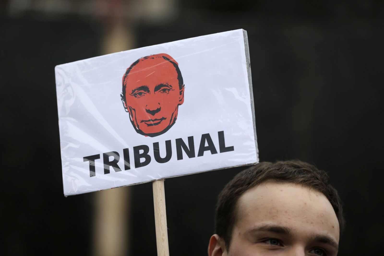 epaselect epa10377660 A protestor holds a banner depicting Russian President Vladimir Putin reading 'Tribunal' during a protest organized by the Russian Democratic Society in Serbia in Belgrade, Serbia, 24 December 2022. Russian troops entered Ukraine on 24 February 2022 starting a conflict that has provoked destruction and a humanitarian crisis.  EPA/ANDREJ CUKIC
