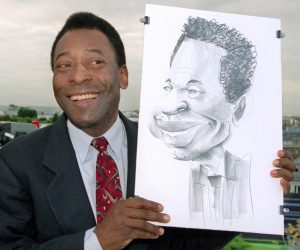 epa10381777 (FILE) - Brazilian soccer legend Pele poses with a caricature of himself at the German TV channel ZDF studio on the roof of a hotel, in Paris, France, 12 June 1998 (reissued 29 December 2022). According to his agent, Pele, whose proper name is Edson Arantes do Nascimento, has died on 28 December 2022 at age 82.  EPA/PETER KNEFFEL *** Local Caption *** 99427778