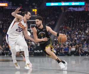 Golden State Warriors guard Klay Thompson (11) drives while defended by Phoenix Suns forward Dario Saric (20) during the first half of an NBA basketball game in San Francisco, Tuesday, Jan. 10, 2023. (AP Photo/Godofredo A. Vásquez)