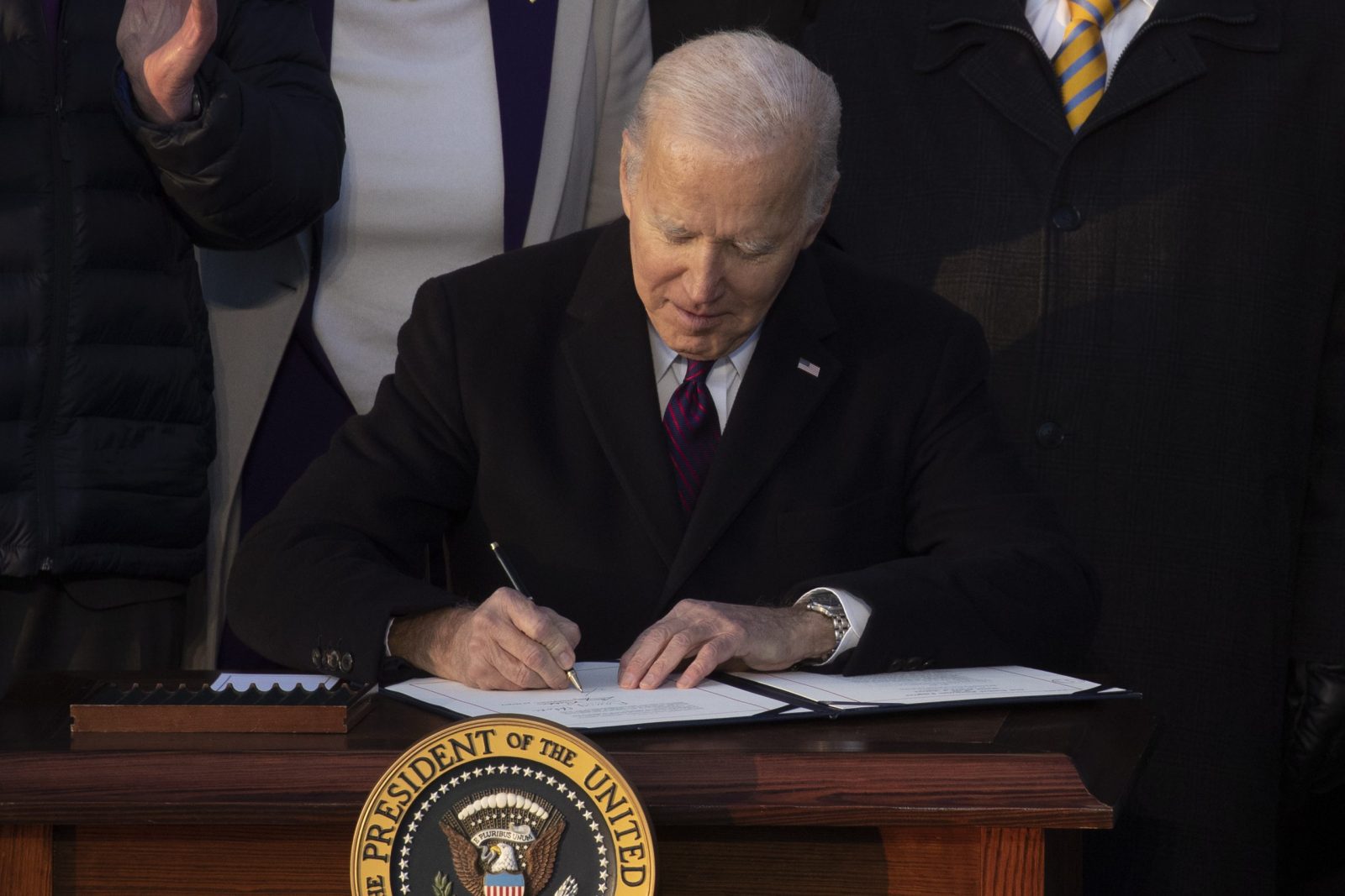epa10364558 US President Joe Biden signs the Respect for Marriage Act beside lawmakers, members of the Biden administration and supporters; during a ceremony on the South Lawn of the White House in Washington, DC, USA, 13 December 2022. The Respect for Marriage Act protects same-sex marriage and interracial marriage.  EPA/MICHAEL REYNOLDS