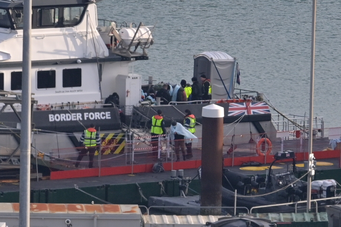 epa10365329 People prepare to disembark a Border Force vessel in Dover Harbour, Dover, Britain, 14 December 2022. A search and rescue operation was launched in the English Channel after an incident involving a small boat was reported. The British Government have reported that three people have died and 43 have been rescued.  EPA/STUART BROCK