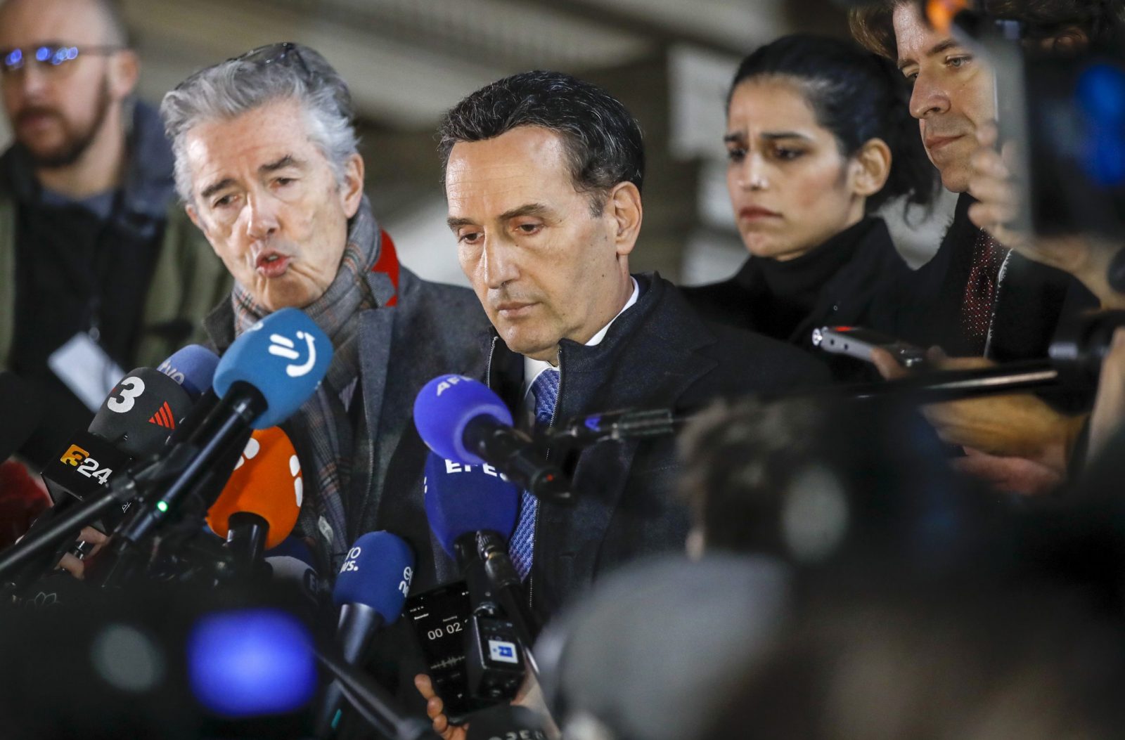 epa10376203 Andre Risopoulos (L) and Michalis Dimitrakopoulos (C), lawyers of Eva Kaili, speak to the media after a pre-trial court hearing in Brussels, Belgium, 22 December 2022. Kaili was dismissed on 13 December from the vice presidency of the European Parliament over allegations of corruption. The Greek MEP and three other suspects were arrested by Belgian police as part of an investigation into suspected corruption and money laundering.  EPA/OLIVIER HOSLET