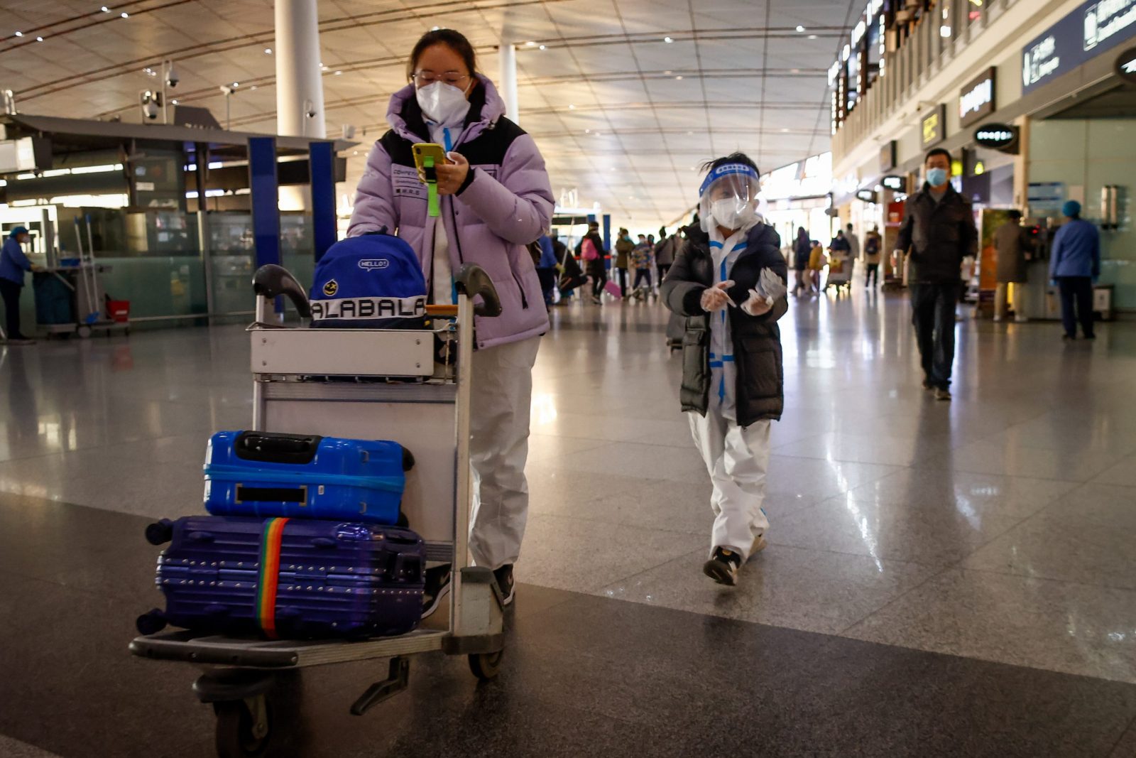epa10384869 Passengers walk inside the Beijing Capital International Airport in Beijing, China, 01 January 2023. The UK and France have joined the USA, Australia, Canada, Spain, Italy, Israel, Japan, South Korea, Morocco, Malaysia, Taiwan and India in imposing curbs for incoming travelers from China as the country continues to experience a surge in COVID-19 with no figures available as China's National Health Commission (NHC) stopped publishing data on 25 December 2022.  EPA/MARK R. CRISTINO