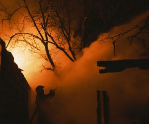 epaselect epa10386755 A rescuer tries to put out a fire of a private building after a Russian shelling in the Ivanivka village near Bakhmut of the Donetsk area, Ukraine, 02 January 2023 amid the Russian invasion. Heavy fighting is taking place in the area since a Russian offensive in November 2022. Bakhmut is still without heating, electricity, and gas due to permanent shelling. Russian troops entered Ukraine on 24 February 2022 starting a conflict that has provoked destruction and a humanitarian crisis.  EPA/GEORGE IVANCHENKO