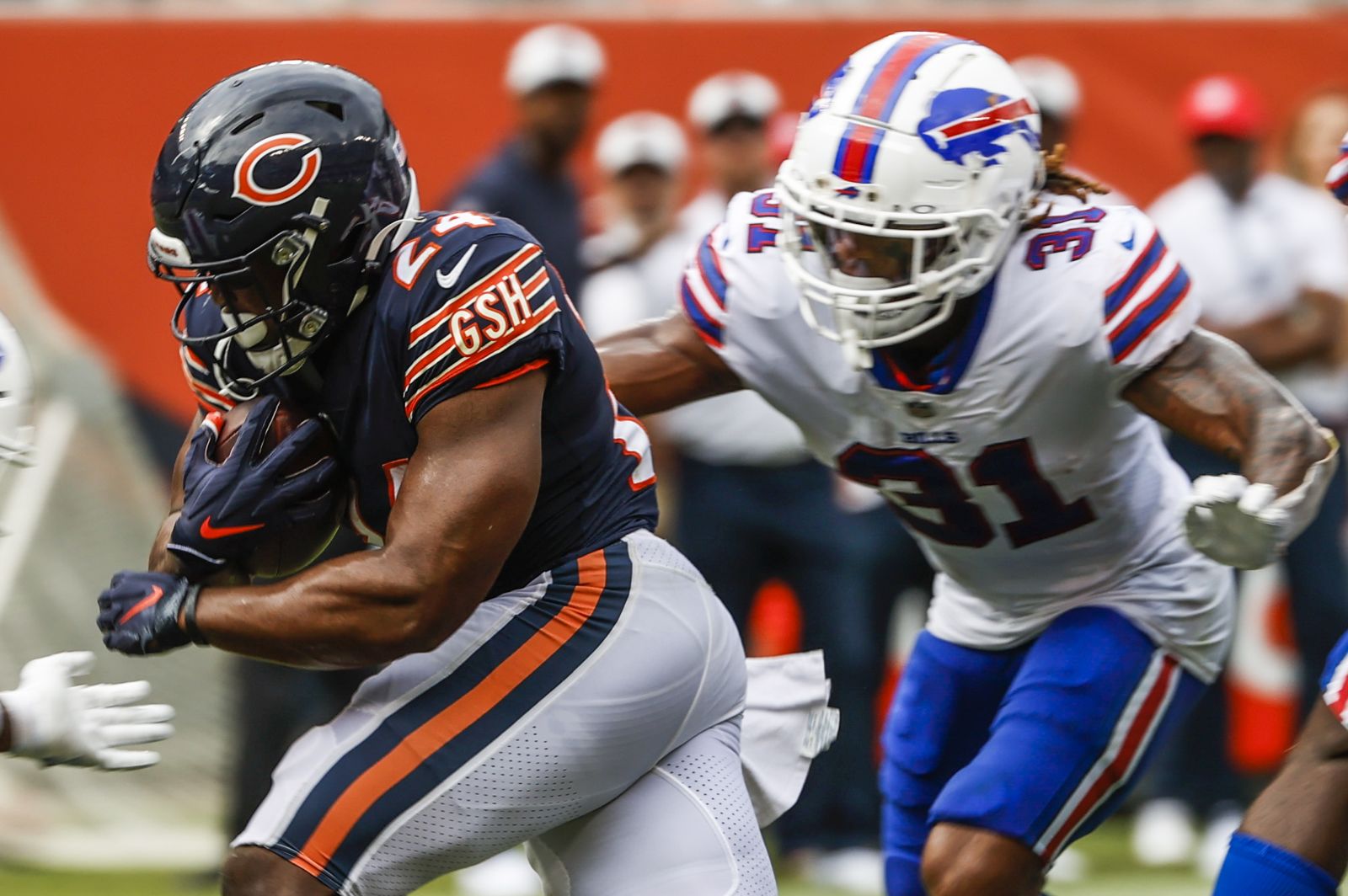 epa10386808 (FILE) - Chicago Bears running back Khalil Herbert (C) runs for a touchdown between Buffalo Bills cornerback Rachad Wildgoose (L) and Buffalo Bills safety Damar Hamlin (R) during the NFL preseason game between the Buffalo Bills and the Chicago Bears at Soldier Field in Chicago, Illinois, USA, 21 August 2021 (issued 03 January 2023.) Twenty-four year old Damar Hamlin collapsed on the field during the Bills NFL game against the Cincinnati Bengals and was administered CPR before being taken to a local hospital 02 January 2023. Players left the field and the game has been suspended by the NFL for the night.  EPA/TANNEN MAURY