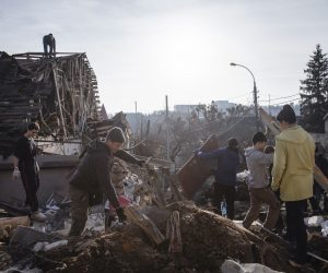 epa10387009 Volunteers clean debris at the site of a Russian missile attack that occured on 31 December 2022 in Kyiv, Ukraine, 03 January 2023. Russian missiles targeted major cities across Ukraine on 31 December prior to the New Year celebration. Russian troops entered Ukraine on 24 February 2022 starting a conflict that has provoked destruction and a humanitarian crisis.  EPA/MIKHAIL PALINCHAK