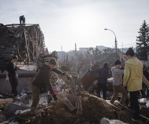 epa10387009 Volunteers clean debris at the site of a Russian missile attack that occured on 31 December 2022 in Kyiv, Ukraine, 03 January 2023. Russian missiles targeted major cities across Ukraine on 31 December prior to the New Year celebration. Russian troops entered Ukraine on 24 February 2022 starting a conflict that has provoked destruction and a humanitarian crisis.  EPA/MIKHAIL PALINCHAK