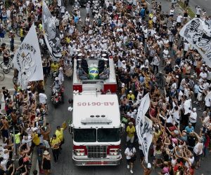 epa10387311 A fire engine carrying the coffin with Pele leads the funeral procession in Santos, Brazil, 03 January 2023. Brazilian soccer legend Pele, born Edson Arantes do Nascimento, died on 29 December 2022 at the age of 82.  EPA/Antonio Lacerda