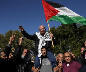 epa10390058 Israeli Arab prisoner Karim Younes (C), the longest consecutively-held inmate in Israeli jails, waves a Palestinian flag as he is carried on a family member's shoulders after being  released after 40 years, while being welcomed at his hometown of Ar'a, Israel, 05 January 2023. Karim Younes, 62, has been jailed since 06 January 1983, accused of the killing of Israeli soldier Avraham Bromberg in 1981. Younes initially was sentenced to death, the verdict was later changed into a 40-years prison term.  EPA/ATEF SAFADI