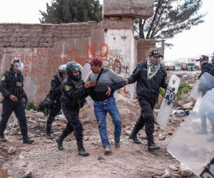 epa10394491 A man is detained by riot police during protests in the vicinity of the Juliaca airport in Juliaca, Peru, 07 January 2022. Protest demonstrations against the government of Dina Boluarte left at least 12 injured on 06 January, including 4 policemen, in clashes around the Juliaca airport in southern Peru, while the prosecutor's office began to investigate the deaths of protesters that occurred in last December. The Ombudsman's Office reported, through its Twitter account, that they went to the Carlos Monge Medrano hospital in Julicaca, and verified 'the existence of 8 civilians and 4 injured policemen', after the clashes at the Inca Manco Capac airport, which closed its operations due to the riots.  EPA/Aldair Mejia