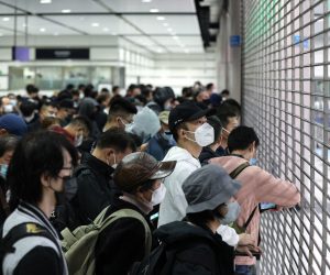 epa10394869 Travellers wait for the Hong Kong immigration desks to open before crossing the border to China at Lok Ma Chau MTR station, in Hong Kong, China, 08 January 2023. From 08 January 2023, after three years of closures due to Covid-19 pandemic restrictions, at least 60,000 people a day are allowed to cross the Hong Kong-mainland China border each way without the need to undergo quarantine. Seven land, sea and air cross-border checkpoints have returned to regular operating hours after three years of closures or limited services under some of the world's toughest and longest pandemic restrictions. A negative polymerase chain action (PCR) test result taken within the past 48 hours is still required to travel to either side of the Hong Kong-China border.  EPA/JEROME FAVRE
