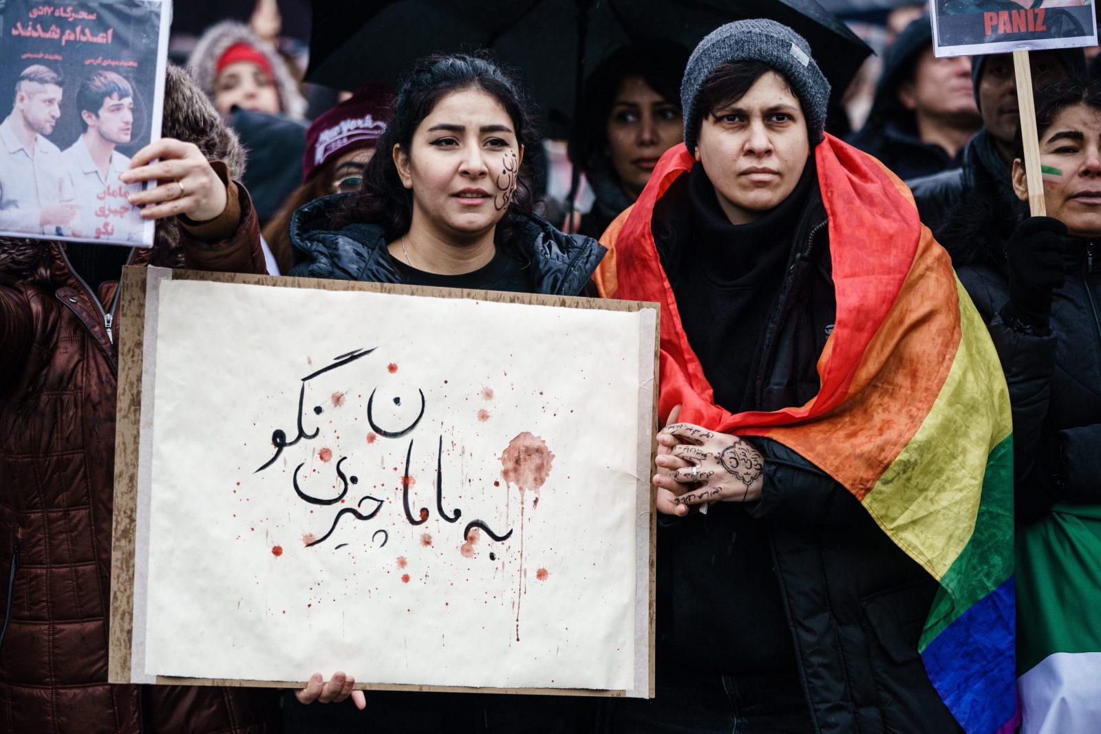 epa10396059 Protesters hold a cardboard in Persian (Farsi) reading in English: ‘don’t tell mama’ which is a quote from one of the executed Iranian protesters in front of the Brandenburg Gate during a rally to commemorate the victims of the Iranian regime in Berlin, Germany, 08 January 2023. Protesters gathered to commemorate the third anniversary of the downing of the Ukraine International Airlines Flight PS752 by Iranian armed forces on 08 January 2020 near Tehran, killing all 176 people aboard. As well as demanding a stop to the ongoing executions in Iran.  EPA/CLEMENS BILAN