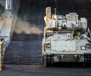 epa10399651 Military equipment of the US army is brought ashore via the port of Vlissingen in the Netherlands, 11 January 2023. Hundreds of tanks and other vehicles will travel by road, rail and water to Poland and Lithuania to strengthen the NATO eastern flank.  EPA/Remko de Waal