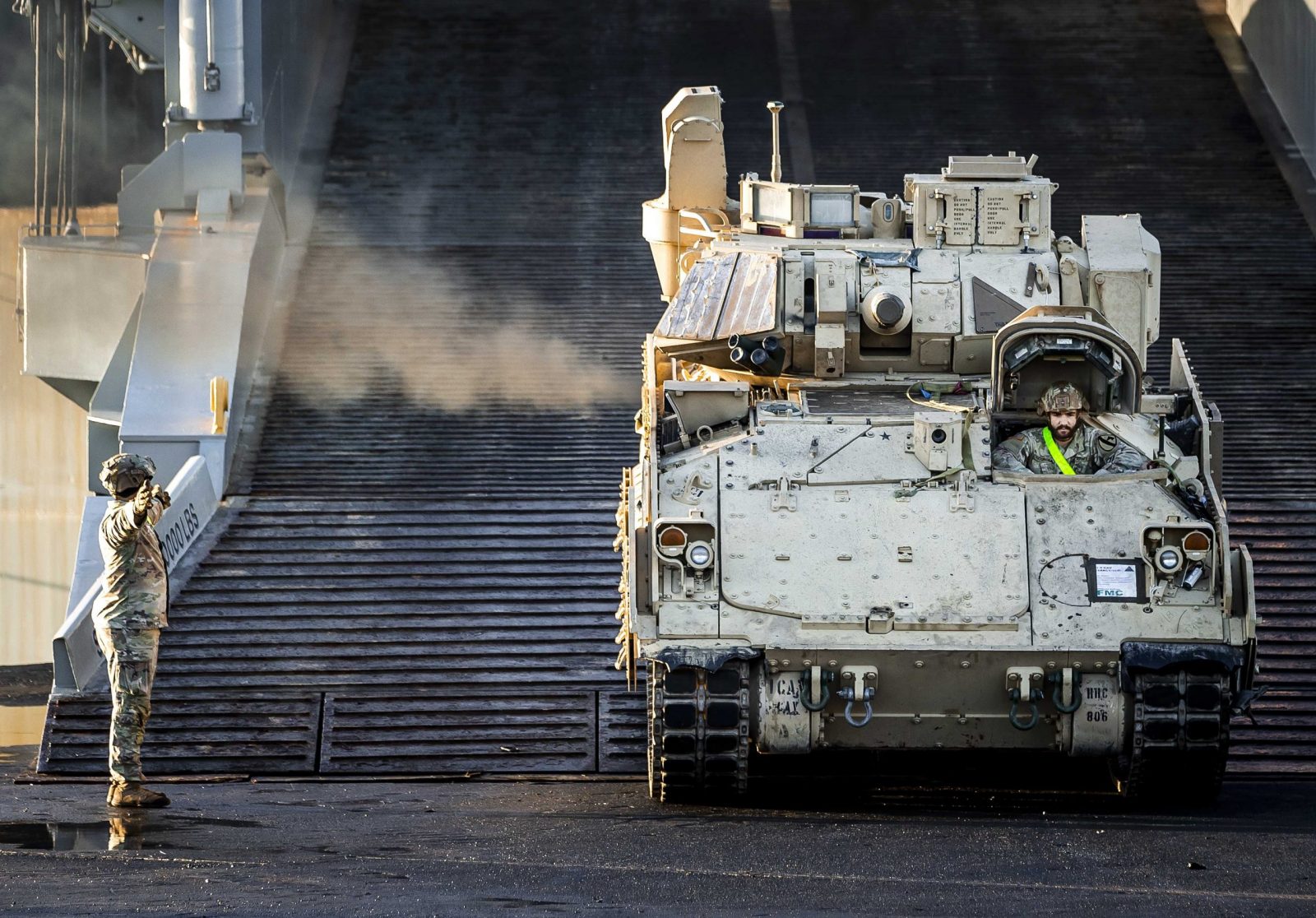 epa10399651 Military equipment of the US army is brought ashore via the port of Vlissingen in the Netherlands, 11 January 2023. Hundreds of tanks and other vehicles will travel by road, rail and water to Poland and Lithuania to strengthen the NATO eastern flank.  EPA/Remko de Waal
