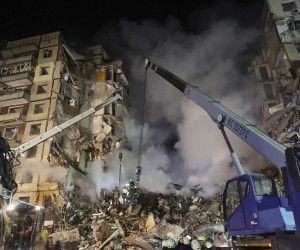 epa10406012 Rescue team work among the rubble of a damaged residential building hit by shelling in Dnipro, southeastern Ukraine, 14 January 2023, amid Russia's invasion. At least five people died and 64 others were injured, among them 14 children, after a rocket hit the nine-story building in Dnipro, the State Emergency Service (SES) of Ukraine reported on 14 January. Russian troops entered Ukraine on 24 February 2022 starting a conflict that has provoked destruction and a humanitarian crisis.  EPA/SERGEY KOZLOV