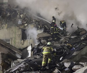 epa10406009 Rescue team work among the rubble of a damaged residential building hit by shelling in Dnipro, southeastern Ukraine, 14 January 2023, amid Russia's invasion. At least five people died and 64 others were injured, among them 14 children, after a rocket hit the nine-story building in Dnipro, the State Emergency Service (SES) of Ukraine reported on 14 January. Russian troops entered Ukraine on 24 February 2022 starting a conflict that has provoked destruction and a humanitarian crisis.  EPA/SERGEY KOZLOV