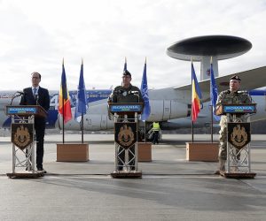 epa10411419 Peer Gebauer, German ambassador in Bucharest (L), Brigadier General Stefan W. Neumann (C), the Commander of the NATO Airborne Early Warning and Control Force E-3A and Romanian Army chief-of staff, General Iulian Berdila (R), backed by the NATO Airborne Warning and Control System (AWACS) military aircraft that just landed at Otopeni Military Airport, deliver their speeches during a welcome ceremony held at Airbase No.90, near Bucharest, Romania, 17 January 2023. The AWACS is used by NATO with the respectively adapted aircrafts for long-range radar surveillance. Three AWACS aircrafts are planned to arrive from their permanent NATO airbase of Geilenkirchen, Germany, in the context of the application of measures to strengthen the defensive posture of the Alliance in the Black Sea region. The three NATO surveillance war planes will be based in Romania for about two months.  EPA/ROBERT GHEMENT