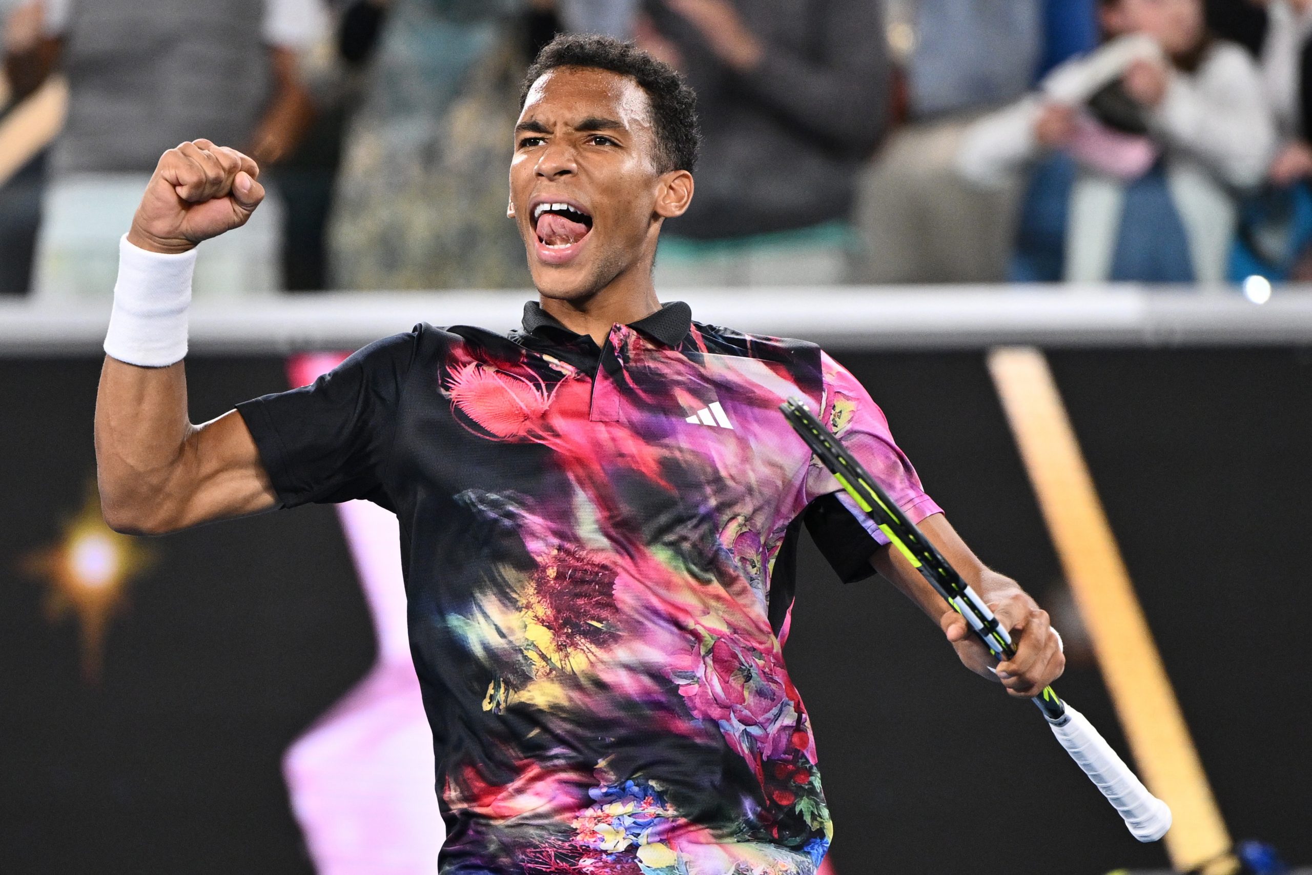 epa10412473 Felix Auger-Aliassime of Canada celebrates winning against Alex Molcan of Slovakia during the 2023 Australian Open tennis tournament at Melbourne Park in Melbourne, Australia, 18 January 2023.  EPA/JOEL CARRETT AUSTRALIA AND NEW ZEALAND OUT