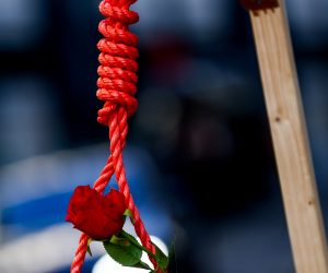 epa10413567 A hanging rope and rose stand near Iranian people protesting outside the Ministry of Foreign Affairs in Brussels, Belgium, 18 January 2023. The protesters are calling Belgian authorities to place Islamic Revolutionary Guard Corps (IRGC) and the Iranian Ministry of Intelligence on the EU and UN 'terrorist list'.  EPA/STEPHANIE LECOCQ