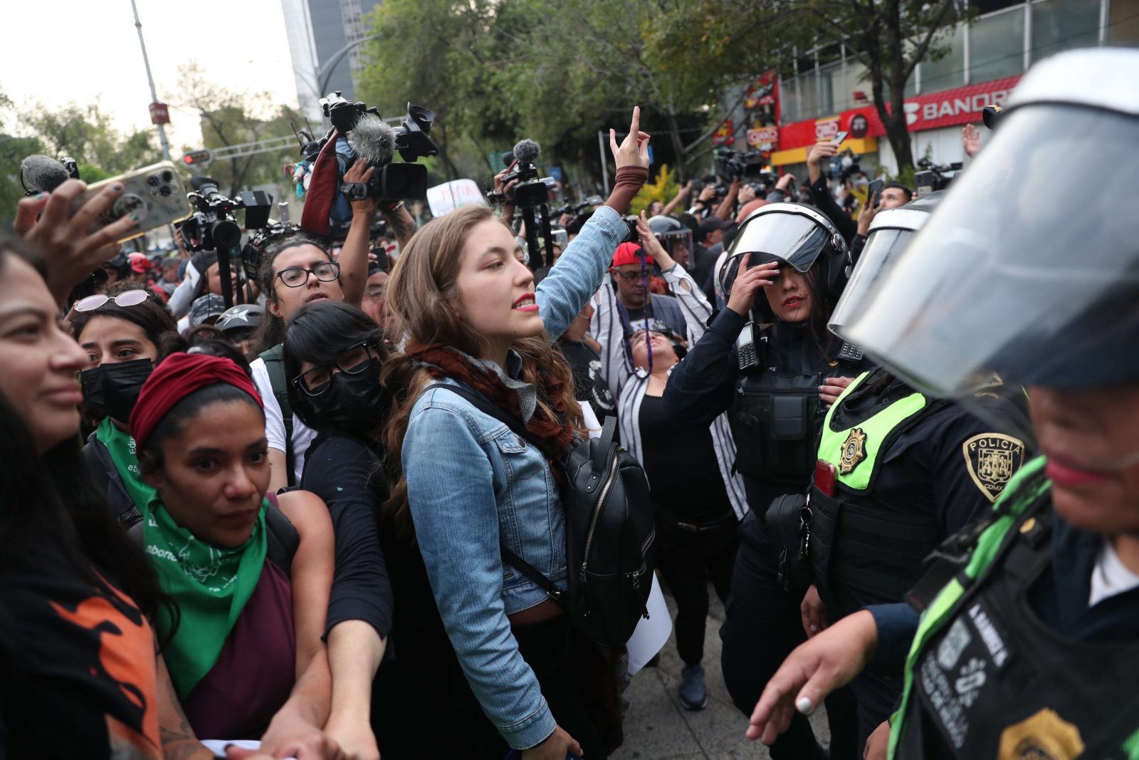 epa10419196 Women protest in front of members of the women's police during a march in Mexico City, Mexico, 20 January 2023. Demonstrators marched to request the withdrawal of the 6,000 National Guard members deployed in the city's subway.  EPA/Sashenka Gutierrez