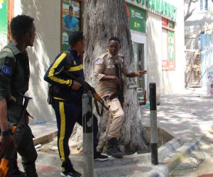epa10423036 Somali policemen keep watch on a side street where gun shots could be heard in Mogadishu, Somalia, 22 January 2023. According to the police an explosion occured near the offices of Mogadishu Mayor and gunfire erupted afterwards. There were no immediate information on possible casualities.  EPA/SAID YUSUF WARSAME