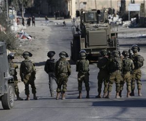 epa10433826 Palestinians throw stones at Israeli troops during clashes after a protest against the killing of nine Palestinians in Jenin at Beita village near the west bank city of Nablus, 27 January 2023. 18 Palestinians were wounded during the clashes, the Palestinian health ministry said.  EPA/ALAA BADARNEH