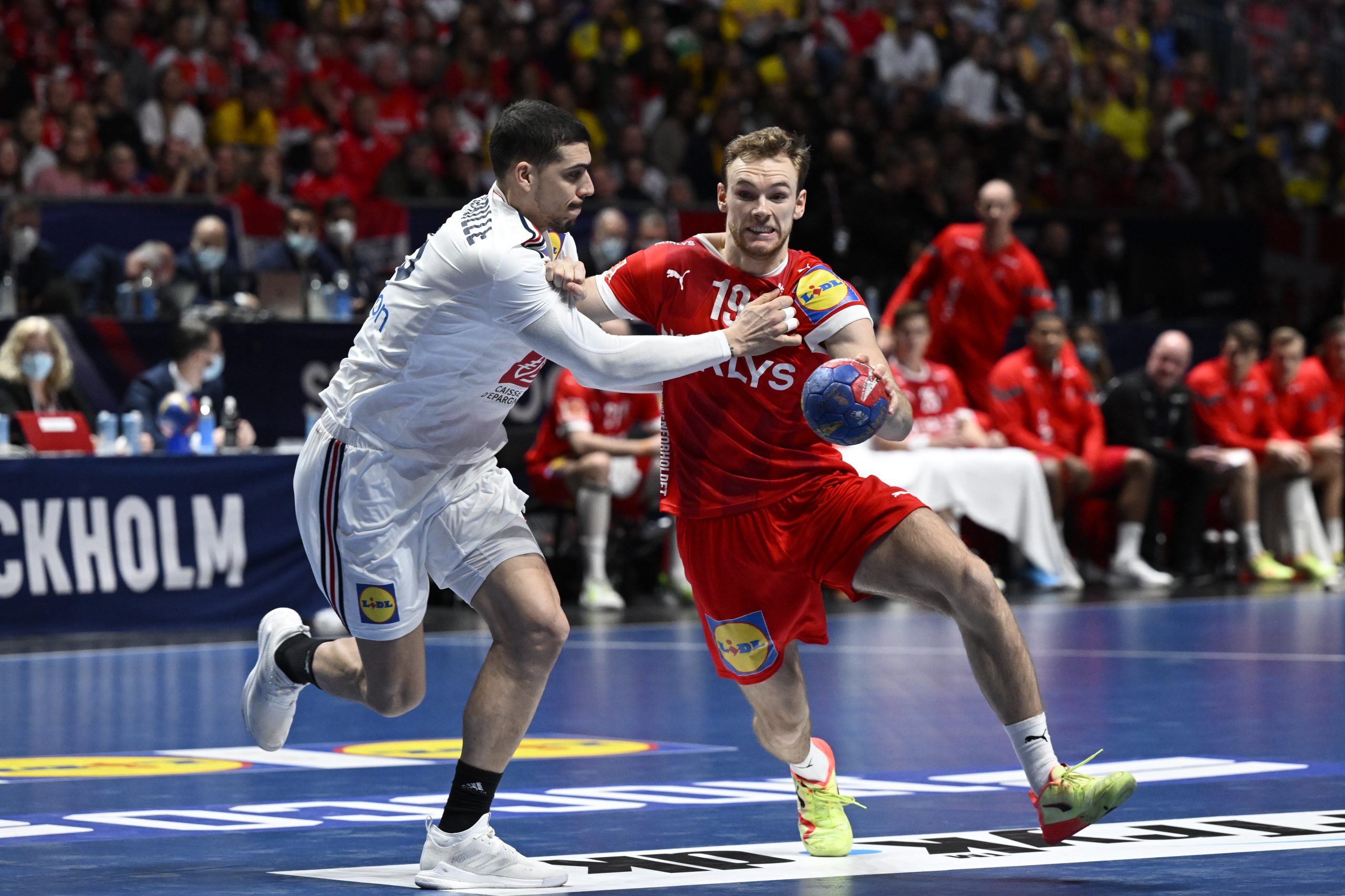 epa10439222 France's Mathieu Grebille and Denmark's Mathias Gidsel during the IHF Men's World Championship handball final match between Denmark and France, in Stockholm, Sweden, 29 January 2023.  EPA/Jessica Gow  SWEDEN OUT